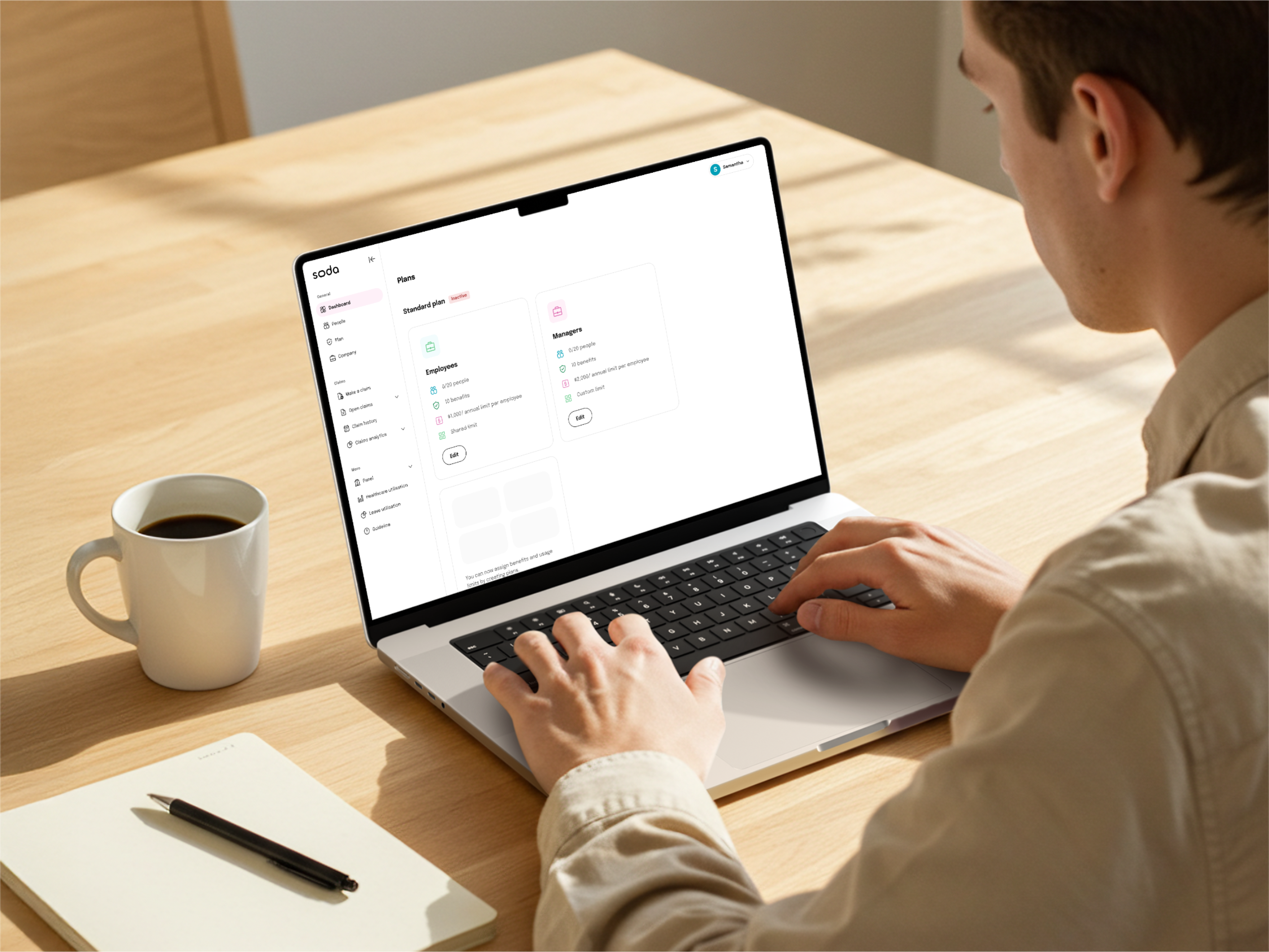 Person using a laptop with the Soda HR portal open, showing the benefits plan setup screen with employee and management plan options.