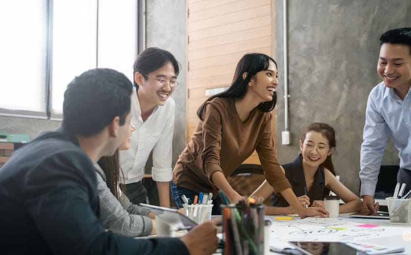 Close-up of an SME decision maker using a calculator at a desk, symbolizing cost planning and financial management